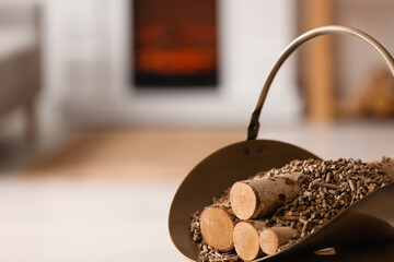 Basket with pellets and firewood in living room, closeup