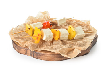 Board with grilled tofu cheese skewers on white background