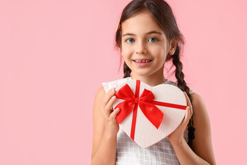 Funny little girl with gift on color background. Valentine's Day celebration