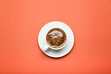 hot americano in white cup on orange background top view 