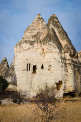 The landscape of valley with natural rock formations known as fairy chimneys, located in Goreme town, Cappadocia region of Turkey