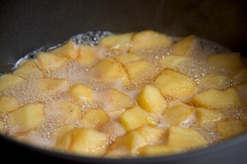 Apple compote boiling in casserole pot