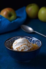 Stewed apple in sweet sauce with ice-cream with fresh apples