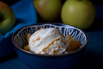 Stewed apple in sweet sauce with ice-cream with fresh apples