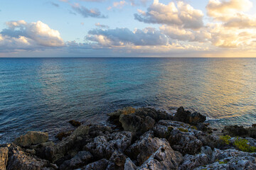 Beautiful view of sunset over the Caribbean sea seen from the shore of tropical island Cozumel, Mexico in Quintana Roo. 