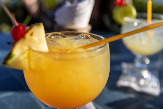 Tropical island drink Mai Tai cocktail loaded with rum with fruit garnish in Cozumel, Mexico