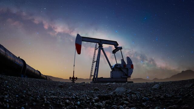 Oil pump jack pumping oil on a starry night. Extracting machinery. Oil industry