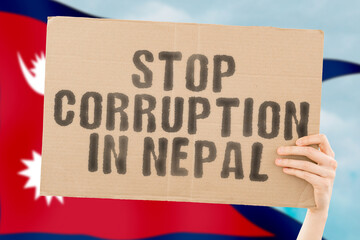 The phrase " Stop Corruption in Nepal " on a banner in men's hand with blurred Nepali flag on the background. Forbidden. Prevent. Wealth. Offence. Corruptness. Economy. Corruptible. Political