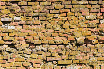 Rough textured surface of an old curved brickwork wall. Background or graphic resource