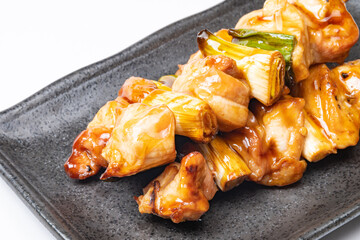 Grilled chicken on a skewer "yakitori" on a plate, Food background, Macro photograph	