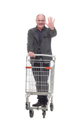 smiling casual man with shopping cart .isolated on a white background.