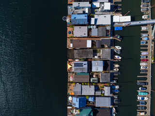 Aerial view. Sea harbor. Lots of sea transport moored in rows. Dark water surface. Sea trade, logistics, business, economics, fishing, boat trips, healthy lifestyle.