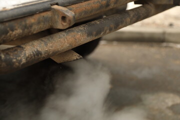 Smoke from the exhaust pipe of a car