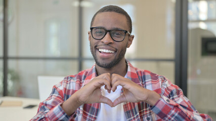 Portrait of African Man showing Heart Shape by Hands