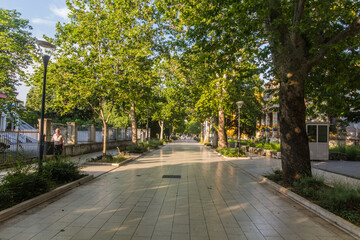 Fototapeta na wymiar MOSTAR, BOSNIA AND HERZEGOVINA - JUNE 10, 2019: Tree lined pedestrian street in Mostar, Bosnia and Herzegovina