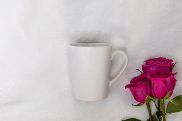Obraz na płótnie Canvas White mug mockup on white plush background with pink roses flat lay for Valentine's Day, Mother's Day, Anniversary, add your text, logo, artwork
