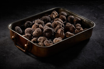 Many truffles in a metal container