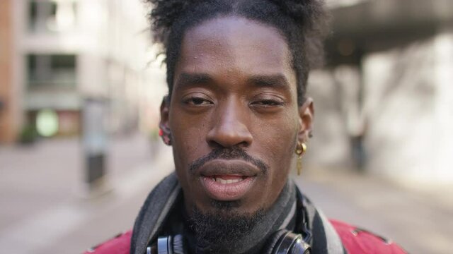 Portrait of young black male talking to camera in a vox pop scenario in the street