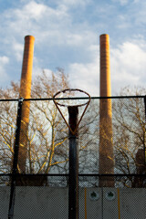 Basketball hoop in front of chimney stacks