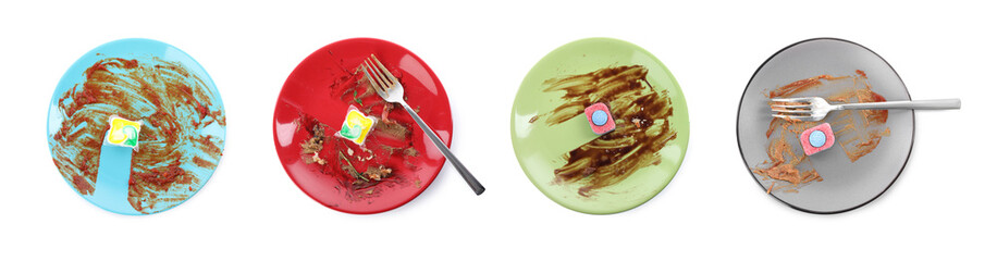 Top view of dirty plates with dishwasher detergent tablets and gel capsules on white background,...