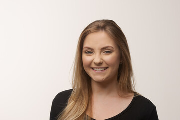 Naklejka premium Young blonde woman isolated in studio portrait