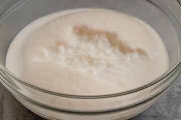Obraz na płótnie Canvas Homemade starter yeast growing. Step by step bread dough recipe, close up view