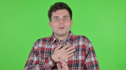 Portrait of Young Man Feeling Scared, Frightened, Green Chroma Screen