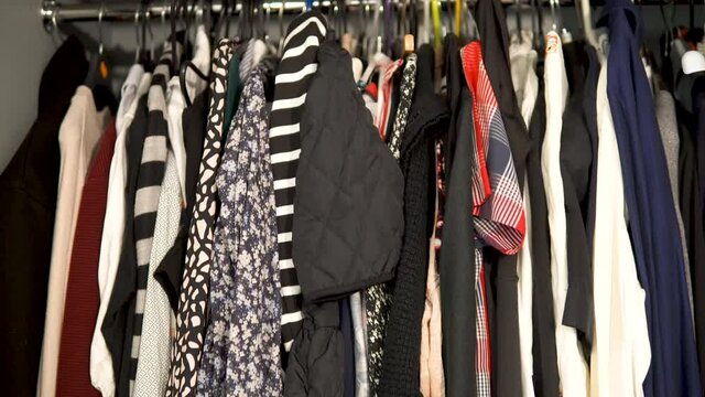 Zoom out shot of wardrobe full with retro vintage clothes of woman at home,close up