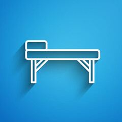 White line Massage table icon isolated on blue background. Long shadow. Vector