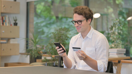 Young Man making Online Payment on Smartphone