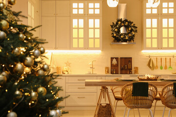 Beautiful Christmas tree in spacious kitchen, closeup. Space for text