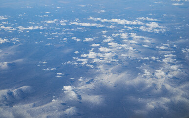 The aerial view of Siberian mountains covered with snow. Russia
