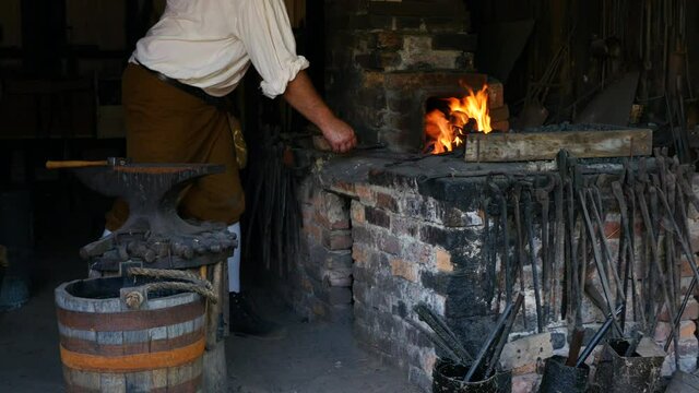 1700s Blacksmith stoking fire WS
