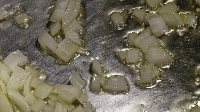 Close-up View of Chopped Onion Sauteing in Pan with Olive Oil, Cooking Pasta Bolognese - Steady Shot