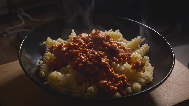 Bowl With Steaming Hot Pasta Bolognese, Cooking Italian Food - Handheld Steady Shot