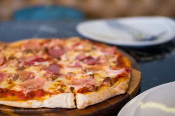 Pizza with bacon and salami.