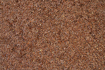 Brown flax seeds.  Close-up of grain, background use.