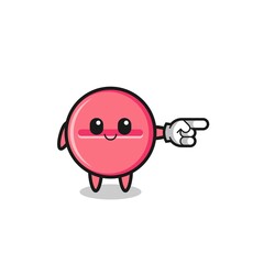 medicine tablet mascot with pointing right gesture