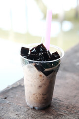 Fototapeta na wymiar Grass jelly with fresh milk in cafe and bakery handmade shop. Delicious and sweet dessert In Thailand