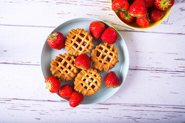 Cupcakes with strawberries and jam, top view, close-up, copy space