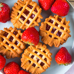 Cupcakes with strawberries and jam, top view, close-up, copy space