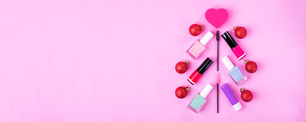 Christmas tree made of decorative cosmetics assortment on pink. Holiday shopping for make-up products. Web banner with copy space