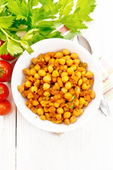 Chickpeas with vegetables stewed in plate on board top