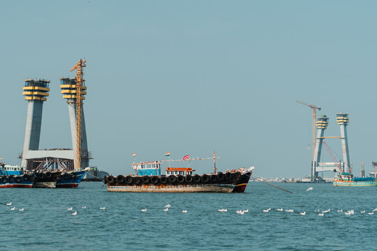 Boat In The Sea In Front Of The Signature Cable Bridge Under Construction Between Okha And Beyt Dwarka At Gujarat, India