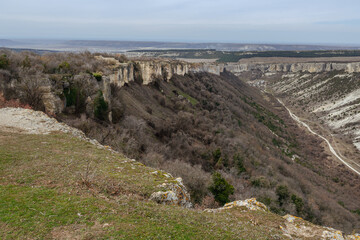 View of wall of cavetown Chufut-Kale from plateau Burunchak. Bakhchysarai, Crimea