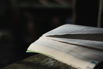 image of open antique book on wooden table and copy space