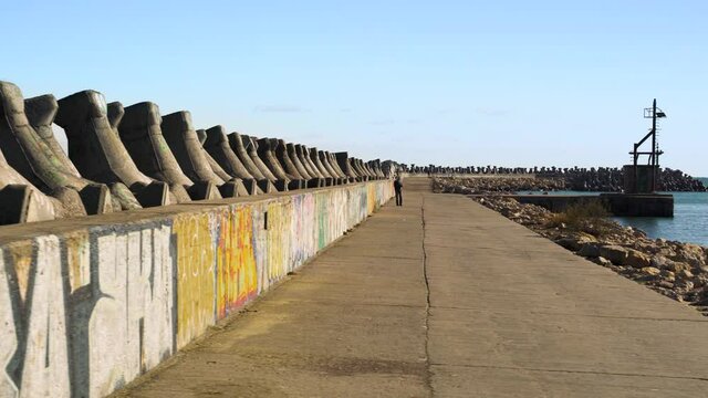 Port of Tomis, near Green lighthouse, walking next to sea and breakwaters