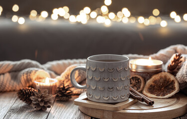 Beautiful christmas cup and candles on blurred background with bokeh.