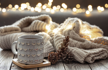 Beautiful christmas cup and candles on blurred background with bokeh.