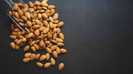 almonds on dark background. healthy food.